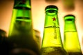 Marinette,WI / U.S.A. - Aug16,2019: Cold bottles of Heineken Beer with drops over green background. Heineken is the flagship produ Royalty Free Stock Photo