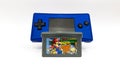 Mario vs Donkey Kong cartridge and a blue Game Boy Micro, smallest handheld video game console from Nintendo