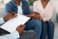 Marital Counselor Taking Notes At Therapy Session With African American Spouses Royalty Free Stock Photo
