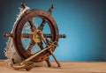 Maritime adventure old anchor and old steering wheel