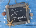 Maritime decoartion with chalkboard and frame showing the message Time to Relax Royalty Free Stock Photo