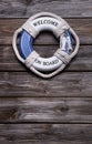 Maritime decoration - life belt on wooden background - concept