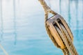 Maritime nautical wooden pulley with ropes of old sailing yacht with sea water background Royalty Free Stock Photo