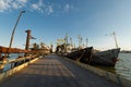 Industrial pontoon bridge with moored ships at repair dock. Maritime transport, naval maintenance, floating platform