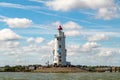 Marken lighthouse and fare off boats under Dutch blue sky Royalty Free Stock Photo