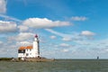 Marken lighthouse and fare off boats under Dutch blue sky Royalty Free Stock Photo