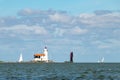 Marken lighthouse and traditional sailing boat under Dutch blue sky Royalty Free Stock Photo