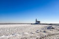The lighthouse of Marken, `het Paard van Marken` in winter and the frozen Markermeer, Holland