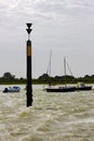 The marker beacon at the entrance to the dredged deep water channel in historic Bosham Harbour in West Sussex in the South of Engl Royalty Free Stock Photo