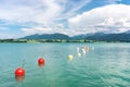 Marker buoys on surface of water. Mountains and thundery clouds. Royalty Free Stock Photo