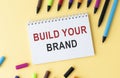 marker pens and note paper written build your brand over Royalty Free Stock Photo