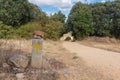 A marker with the yellow arrow that shows the right way along the Camino de Santiago in Spain. Royalty Free Stock Photo