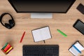 Markers with open notepad on wooden desk