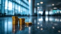 Market breakout signals. Stacked gold coins create striking visual against blurred background,