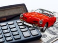 Market car concept. Red vintage Toy car calculator and 100 money dollars bills or banknotes Royalty Free Stock Photo