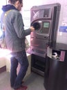 Man using reverse vending machine