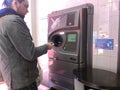 Young man using reverse vending machine Royalty Free Stock Photo