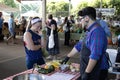 A market chef talks with a woman during a cooking demonstration. Royalty Free Stock Photo