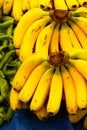 Market counter with yellow bananas. Ripe fruits and vegetables on farmer market. A vertical shot. Healthy organic food. Selective