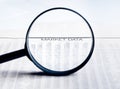 Market data words see through lens of loupe on financial newspaper Royalty Free Stock Photo
