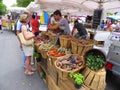 People buying at an outdoor market stall