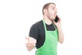 Market employee explaining something on phone