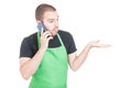 Market employee making not knowing gesture at phone