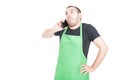 Market employee making not knowing gesture at phone