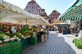 Weekly farmers market in front of ancient historic houses, half timbered houses of Swabian Hall, Baden-Wuerttemberg, Germany. Royalty Free Stock Photo