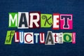 MARKET FLUCTUATION text word collage, multi colored fabric on blue denim, stocks price changes concept