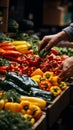 Market goer handpicks an assortment of colorful vegetables, supporting local produce