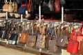 Market for handbags and purses on the street. Imitation of brand bags. Fake branded ladies hand Royalty Free Stock Photo