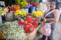 Market daily life view. woman buying flowers