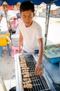 Market man selling grilled pork.