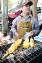 Bangkok, Thailand : Market man selling grilled squ