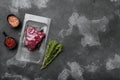 Market pack with raw rump beef steak, on black dark stone table background, top view flat lay, with copy space for text Royalty Free Stock Photo