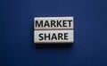 Market Share symbol. Wooden blocks with words Market Sharer. Beautiful deep blue background. Business and Market Share concept.