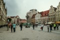 Market square of Wroclaw, also called Rynek, with pedestrians walking in crowd.
