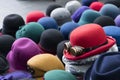 A pile of multicoloured bowler hats on a stall