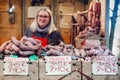 Market stall of italian salami with a woman on background
