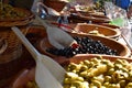 Market stall selling large choice of olives.