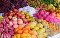 Market stall with tropicl fruits, dragon fruit, mango, apples, mandarins, joufull colors Royalty Free Stock Photo