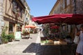 Market stalls set up in the streets of Monpazier, a bastide town in the Lot et Garonne, France