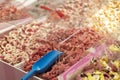 Market stand in candy shop with boxes of red pink candy, sweets