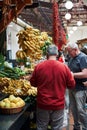 Market, surrounded by a variety of colorful and fresh produce fruits and vegetables