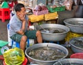 A market trader selling live fish around the Central Market in Phnom Penh, Cambodia