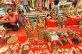 Market traders selling vintage souvenirs and new artworks by asian jewelers and artisans