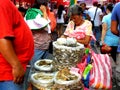 Market vendor selling dried fish in a market in philippines