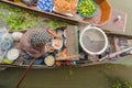 Market woman cooking noodle at Damnoen Saduak Floating Market or Amphawa. Local people sell fruits, traditional food on boats in Royalty Free Stock Photo