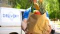 Market worker giving grocery bag, goods delivery service, express food order Royalty Free Stock Photo